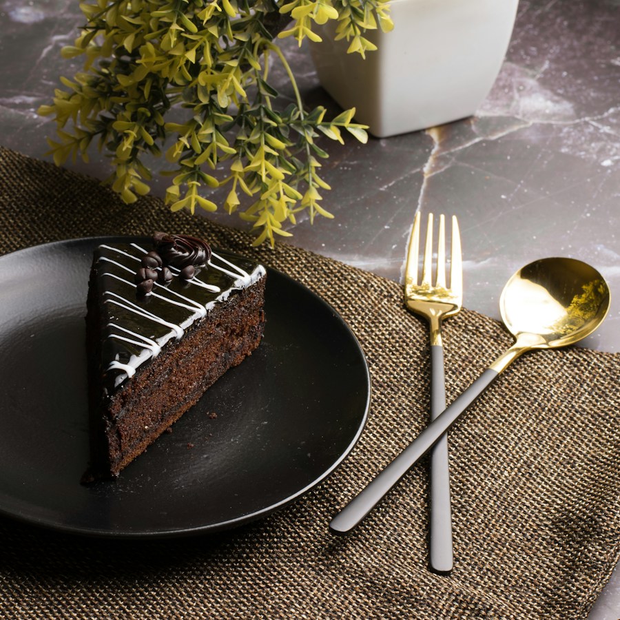 Chocolate cake on a dark plate with a fork