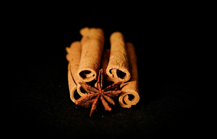 Cinnamon sticks and star anise arranged on a dark background